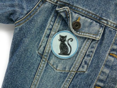 Katzen-Jeansflicken auf Jeansjacke aufgebügelt, hellblauer Jeansstoff Ø 5,5 cm mit einzelner schwarzer Katze gestickt, Bügelflicken oder Deko-Aufnäher handmade Berlin