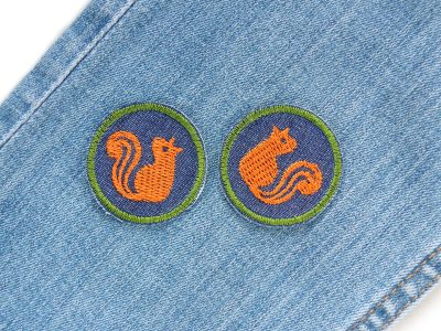 Eichhörnchen-Jeansflicken auf Jeanshose aufgebügelt, dunkelblaue Jeans-Bügelflicken Ø 4 cm mit orangem Eichhörnchen gestickt, Mini-Aufnäher für Shirts Jacken Taschen Piratenbande Berlin