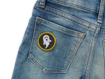 Mini Gespenster Patches goldgelb auf Kinderhose aufgebügelt, schwarzer Jeansstoff Ø 4 cm mit weißen Gespenstern und goldgelber Umrandung, Bügelflicken handmade Berlin Piratenbande