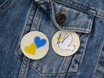 Ukraine Solidarität Aufnäher - 2 gestickte Patches aus hellem Jeansstoff mit Friedenstaube und Herzen in Blau & Gelb auf eine Jeansjacke aufgebügelt, Größe: jeweils 4,5 cm im Durchmesser, handmade in Berlin